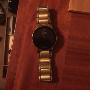 Gold citizen eco drive watch.
